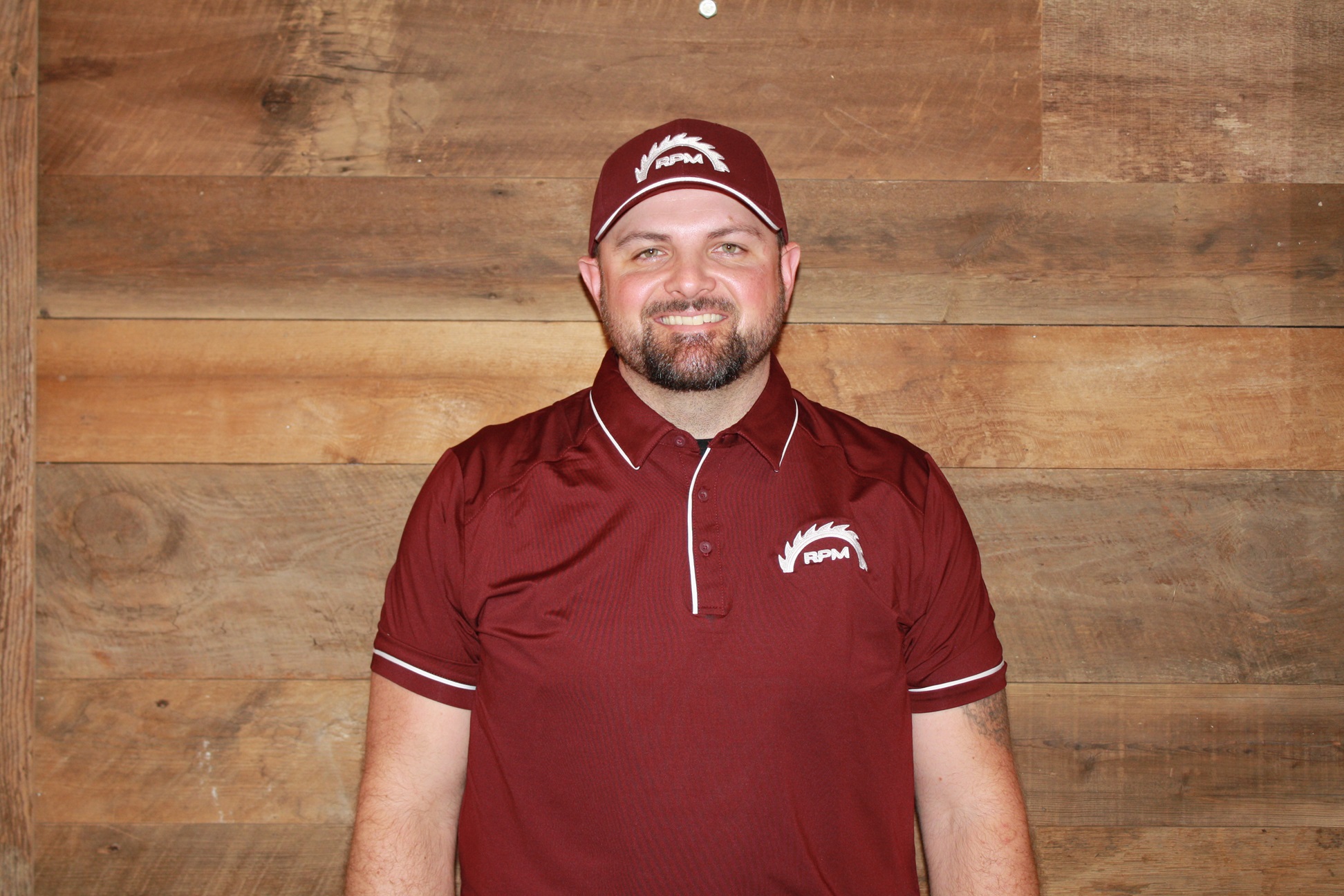 Nick Thuemler in a red RPM shirt and matching baseball cap