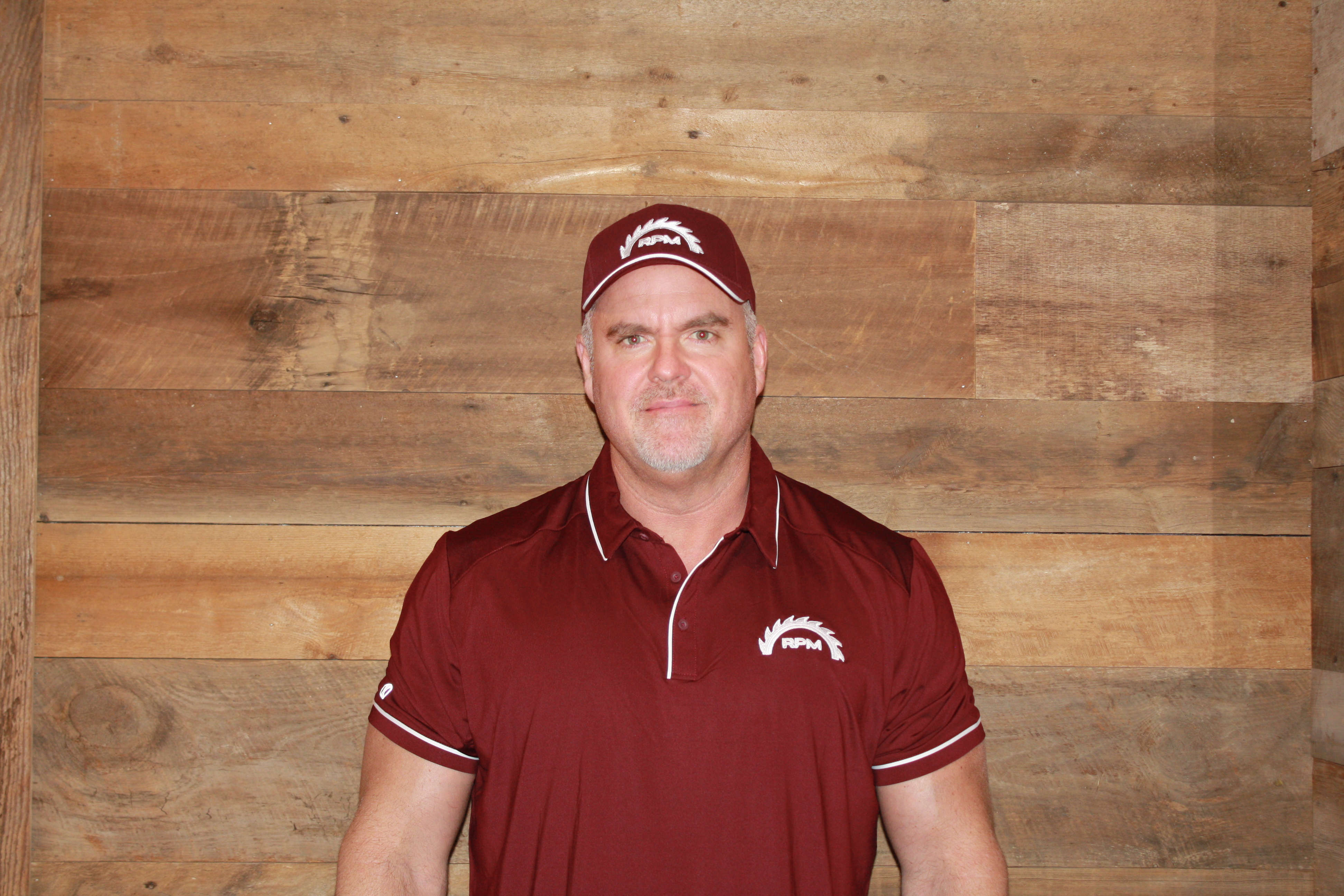 Shawn Guibergia in a red RPM shirt with wood panelled background